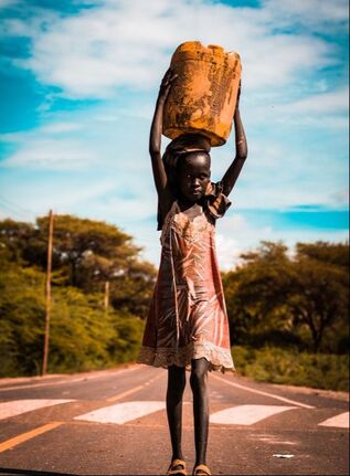 Picture of young Kenyan Girl carrying water container