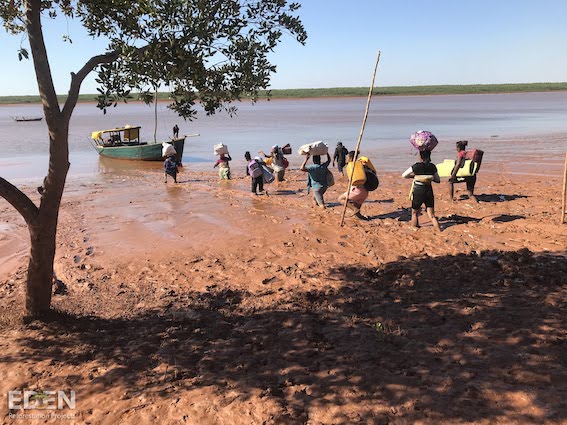Photo of local community members heading back to their boats after planting trees in Madagascar