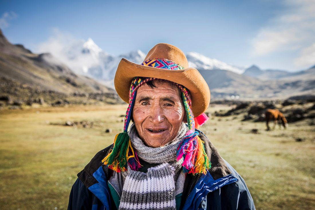 Picture of a smiling Peruvian man in a traditional hat. 